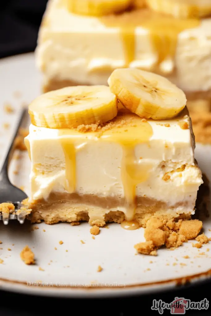 Close-up of a banana pudding cheesecake square revealing its creamy texture and banana chunks.
