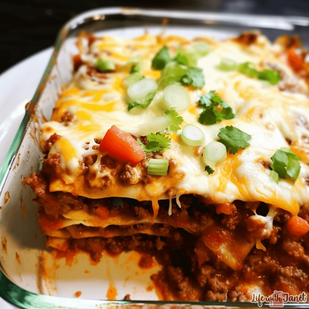 Close-up view of layered taco lasagna showing beef, beans, and tortillas