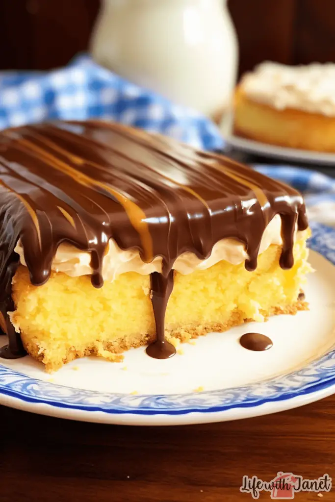 Close-up view of a slice of Boston Cream Poke Cake, showcasing its moist layers and rich chocolate topping.