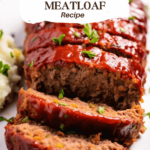 Close-up view of a freshly baked Stove Top Stuffing Meatloaf with a glossy ketchup glaze on top, set on a white platter.