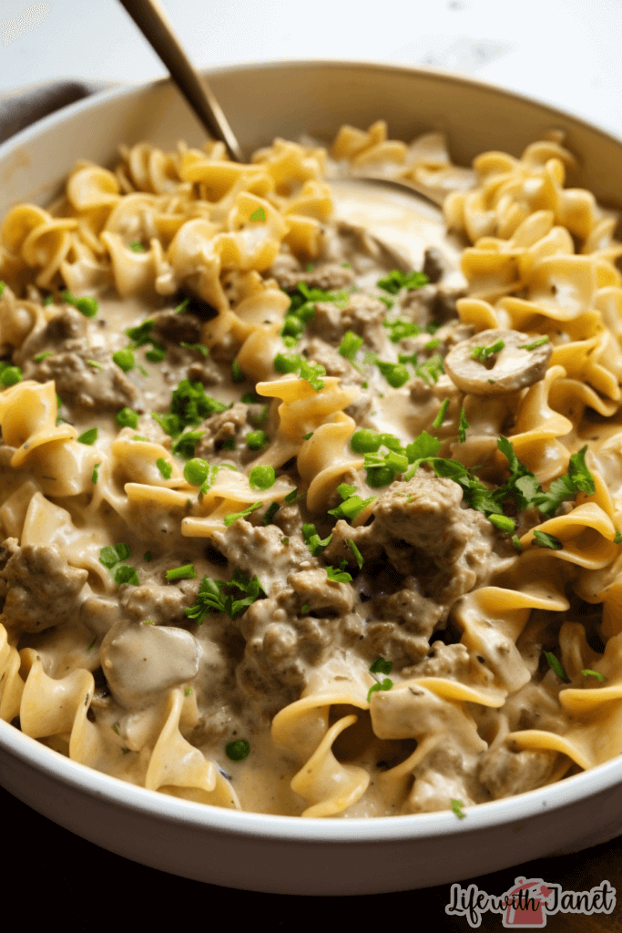 Golden brown, freshly baked Beef Stroganoff Casserole in a dish, with steam rising, indicating its mouth-watering warmth.