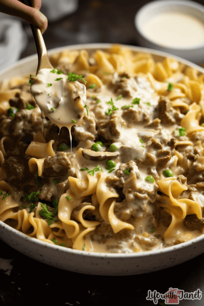 Assorted ingredients like ground chuck, diced mushrooms, egg noodles, and containers of sour cream and ranch dressing laid out on a kitchen counter.