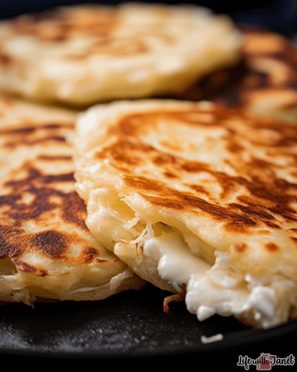 freshly cooked pupusa, highlighting its golden-brown exterior and the visible hints of cheese and beans in the center. This will give readers a sense of texture and deliciousness.