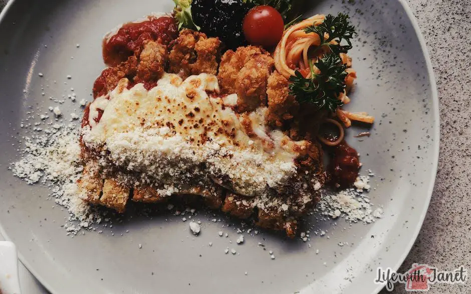 Image of delicious chicken parmesan dish with crispy breaded chicken breasts covered in melted cheese and marinara sauce, served with pasta.